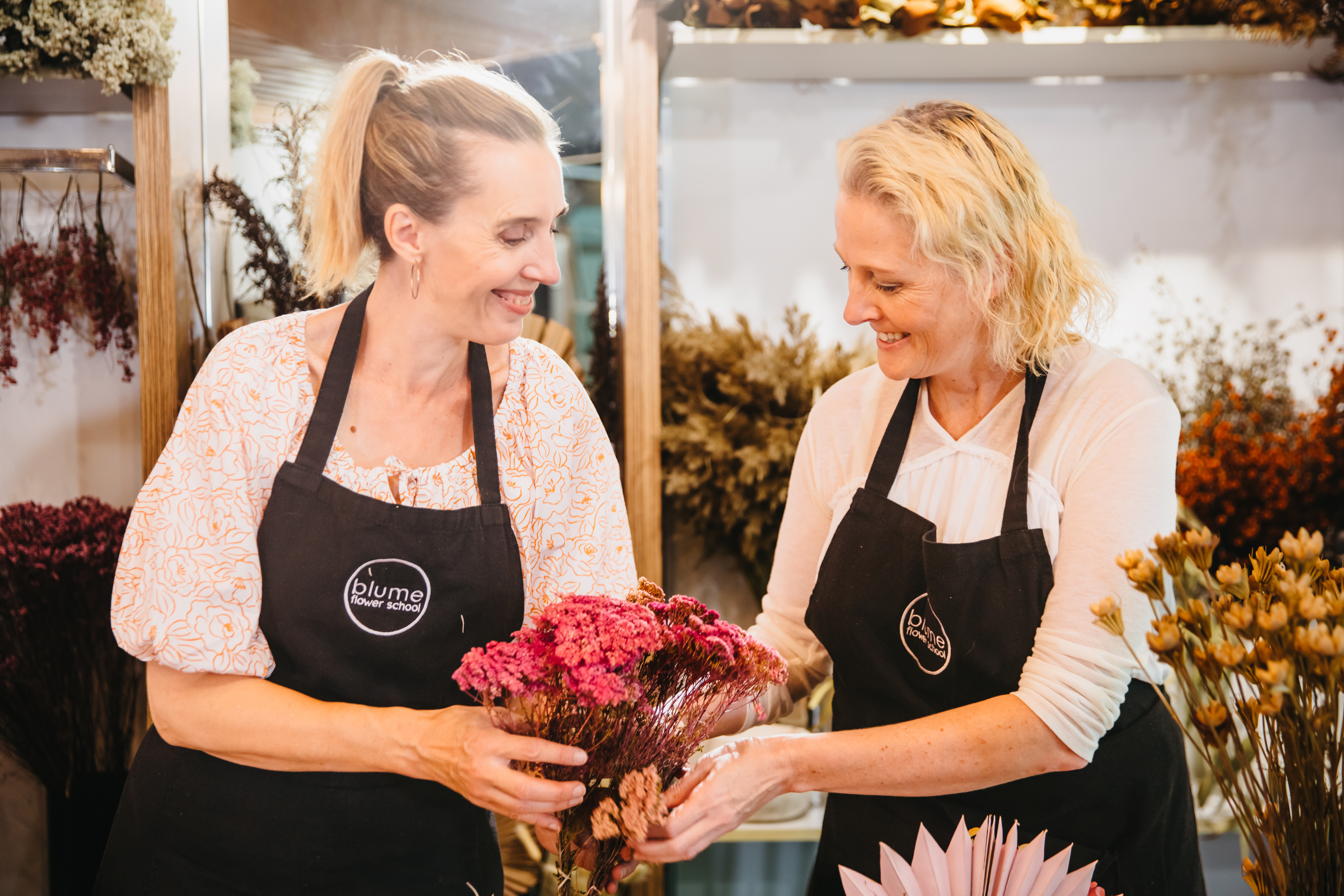 Two women smiling at a floristry class